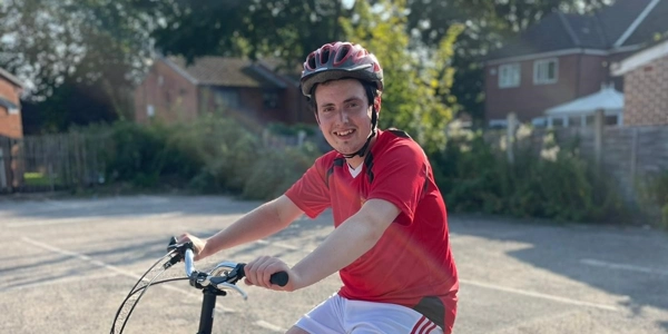 image of boy on a red bike